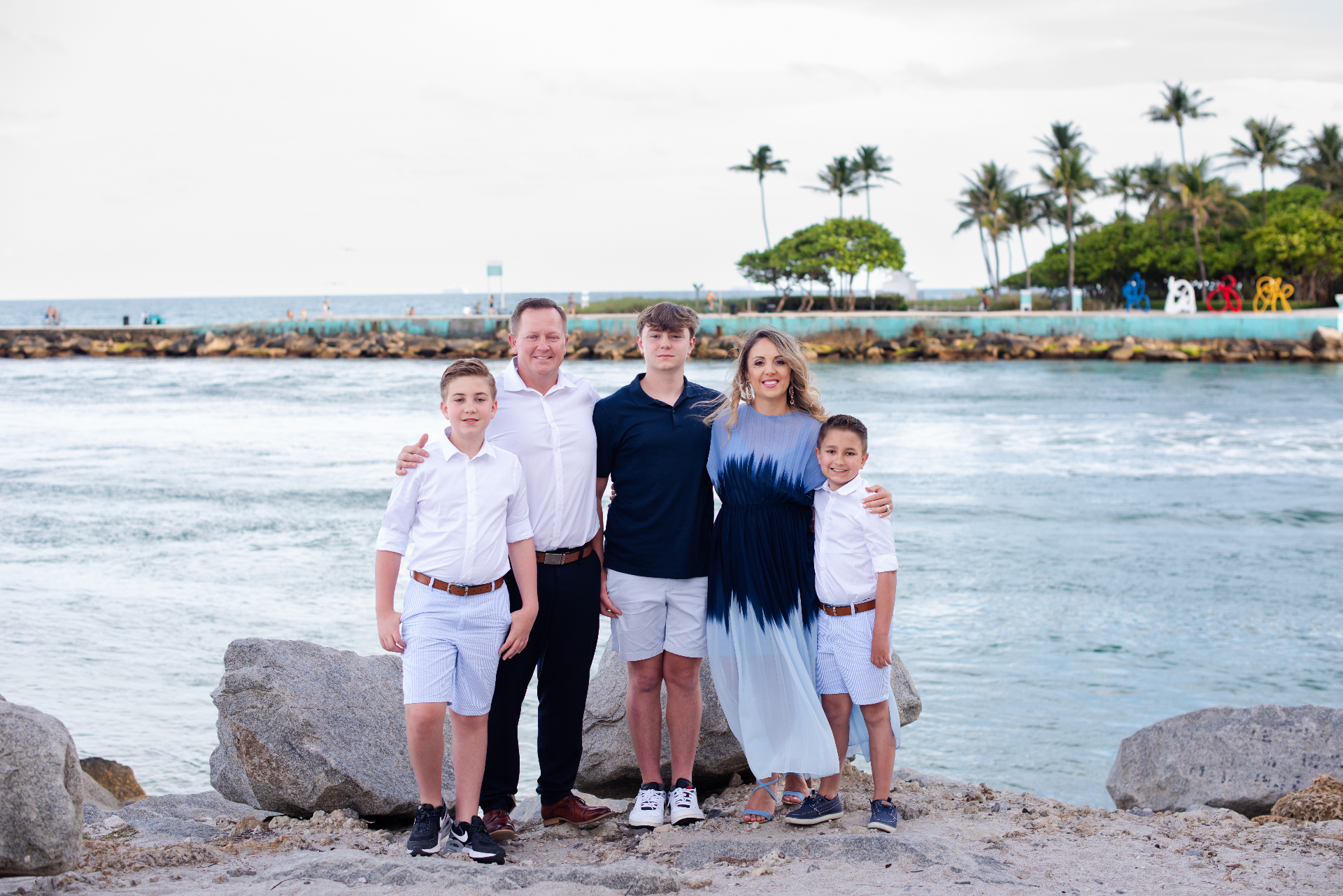 Margaret with her husband and three sons by the water